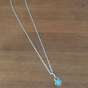 Silver necklace with oval shaped blue stone